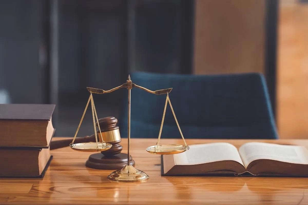 Scales of justice and a law book, representing the changes to the Golden Visa law.