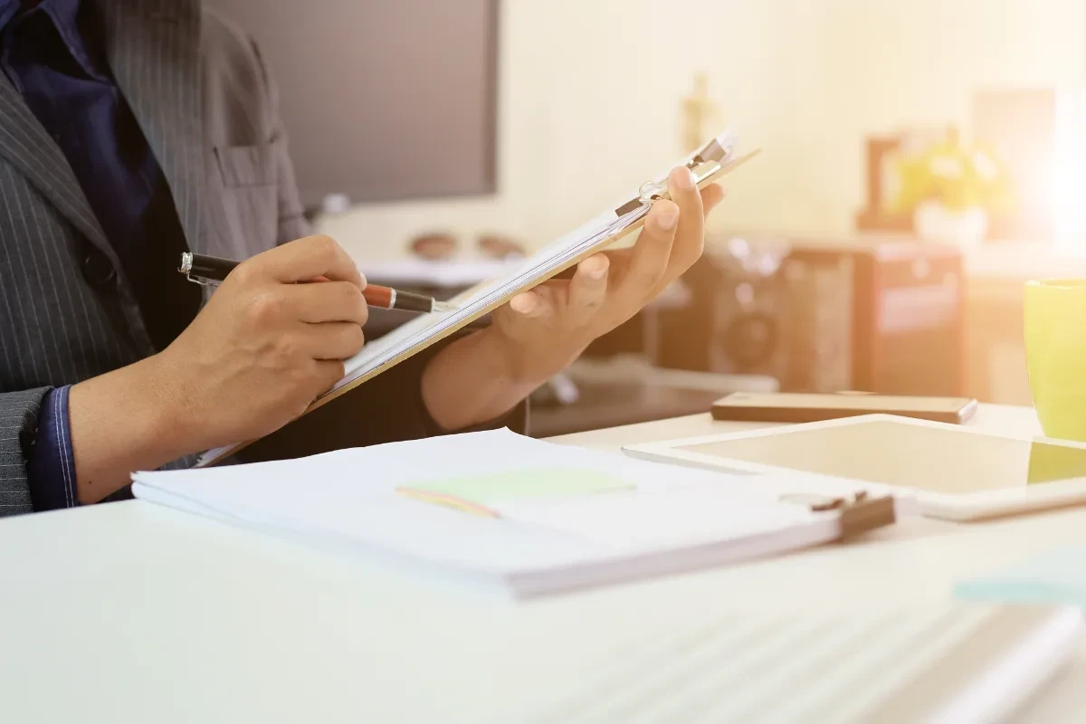 An audit checklist on a document, reflecting the pre-reservation due-diligence steps every Greece Golden Visa buyer should complete.
